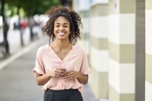 portrait of smiling young woman in the city 2022 12 16 22 20 08 utc 1